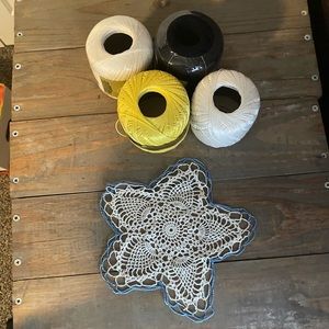 Bundle of doily crochet yarn and a vintage doily